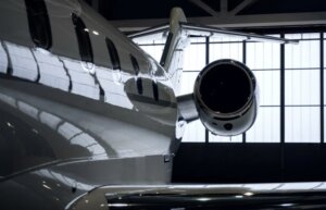 Close-up of a luxury private jet inside a hangar, symbolizing premium airport transportation and black car service for high-end travelers.